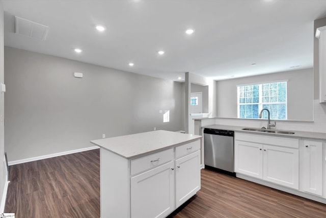 kitchen featuring light countertops, visible vents, stainless steel dishwasher, dark wood-type flooring, and a sink