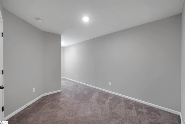 carpeted empty room with baseboards