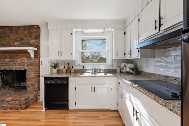 kitchen featuring black appliances, a sink, and white cabinetry