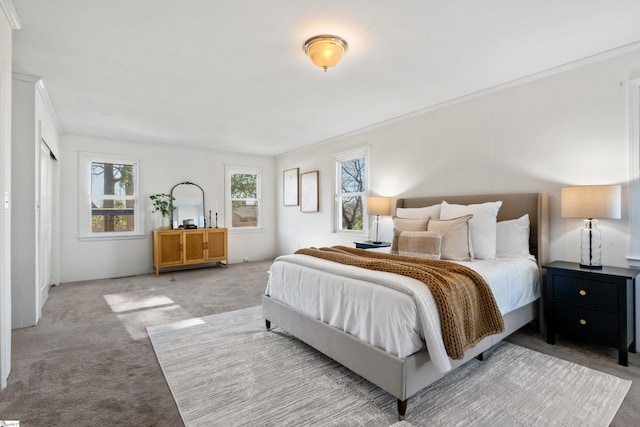 bedroom with light carpet and crown molding