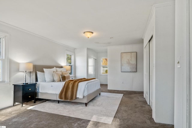 carpeted bedroom with ornamental molding