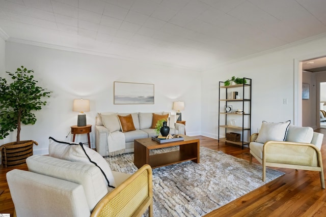 living area featuring ornamental molding, wood finished floors, and baseboards