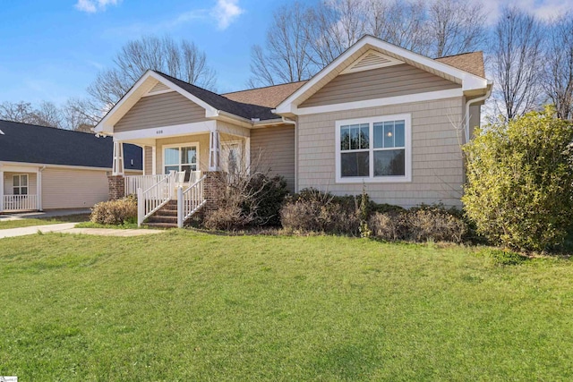 view of front facade featuring covered porch and a front yard