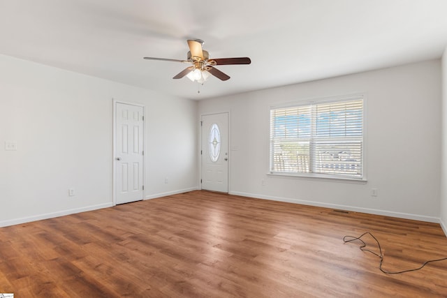 foyer entrance featuring ceiling fan, wood finished floors, and baseboards