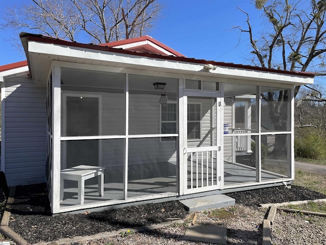 view of outdoor structure with a sunroom