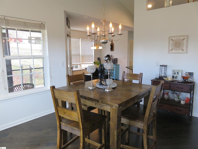 dining space with dark wood-style floors, baseboards, vaulted ceiling, and a notable chandelier