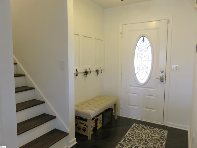 foyer featuring dark wood-style floors and stairway