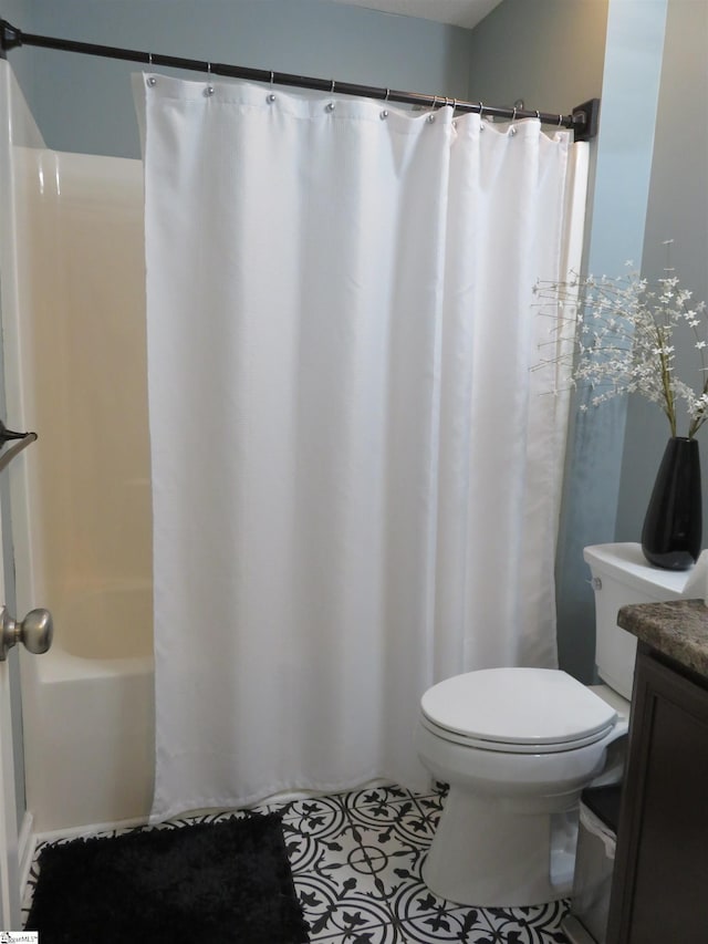 full bathroom with vanity, toilet, and tile patterned floors