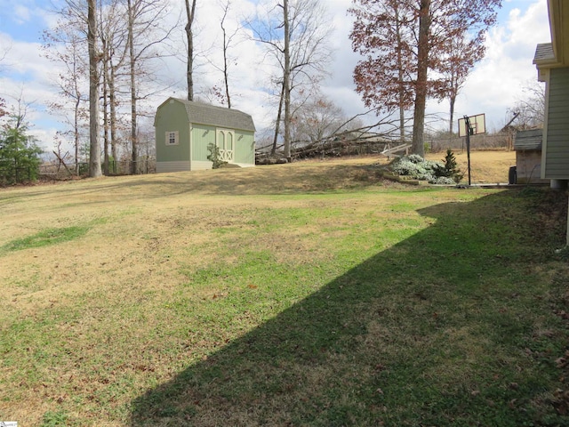 view of yard featuring an outbuilding, fence, and a shed