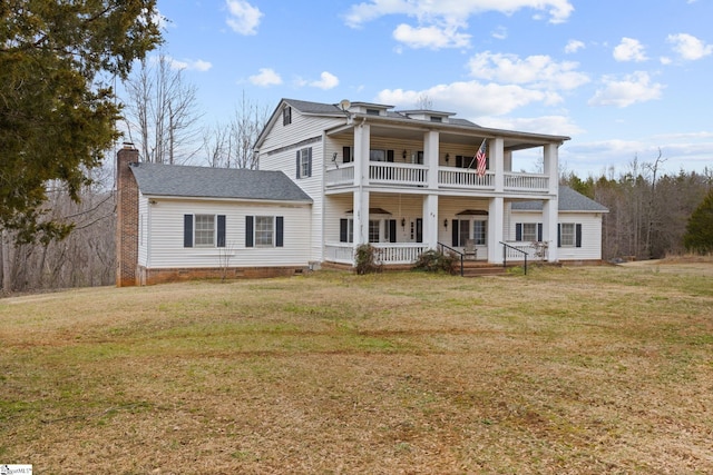 view of front of property featuring a balcony, a chimney, crawl space, covered porch, and a front lawn