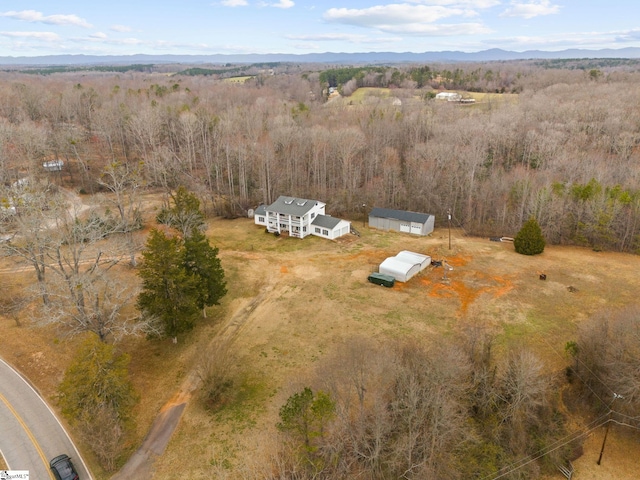 birds eye view of property with a forest view and a mountain view