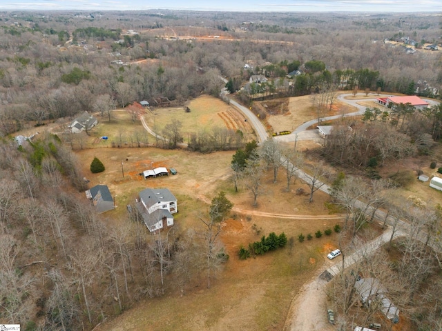 drone / aerial view with a view of trees and a rural view