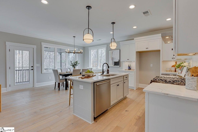 kitchen with visible vents, white cabinets, dishwasher, light wood-type flooring, and a sink