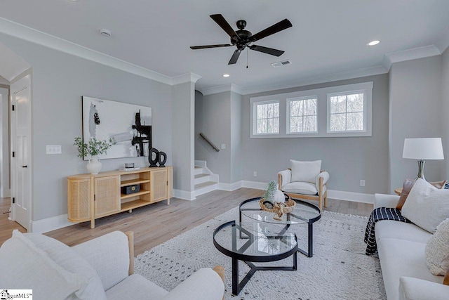 living room with visible vents, crown molding, stairway, and wood finished floors