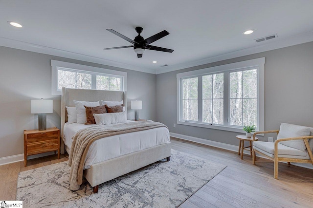 bedroom featuring recessed lighting, wood finished floors, visible vents, baseboards, and crown molding