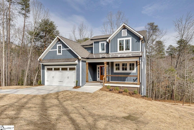 view of front of home featuring a standing seam roof, covered porch, a garage, driveway, and board and batten siding