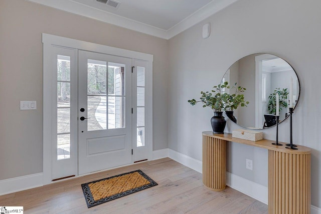 entryway with baseboards, wood finished floors, and crown molding