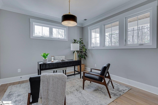 office area featuring visible vents, crown molding, baseboards, and wood finished floors