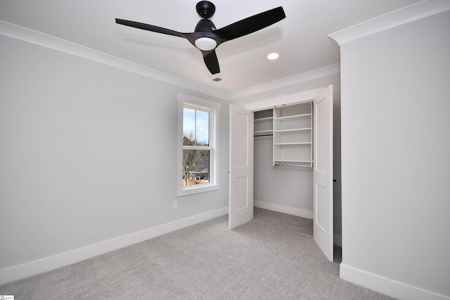 unfurnished bedroom featuring carpet, a closet, ornamental molding, a ceiling fan, and baseboards