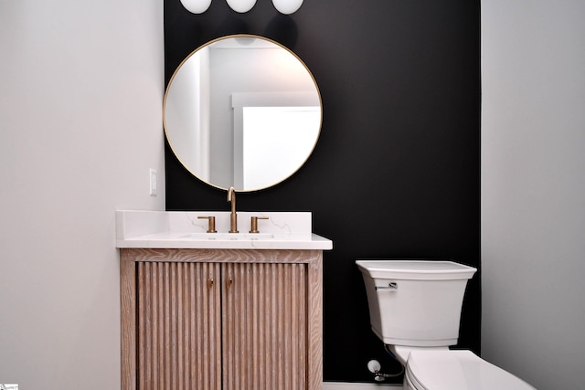 bathroom with toilet and vanity