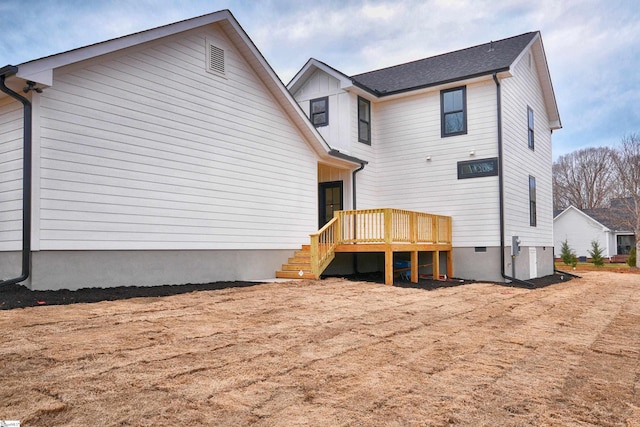 back of property with a wooden deck