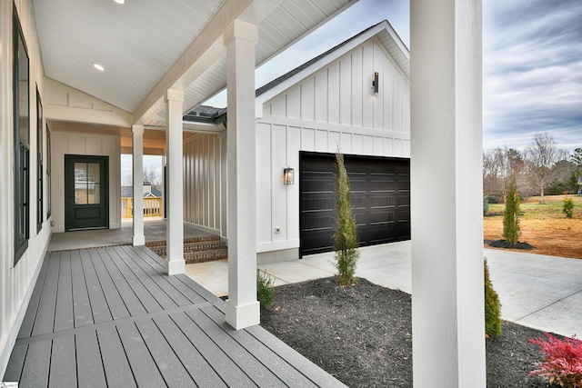 entrance to property featuring an attached garage and board and batten siding