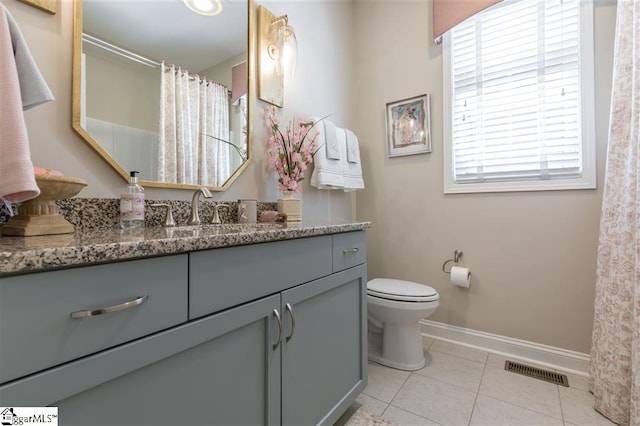 full bathroom featuring visible vents, toilet, vanity, baseboards, and tile patterned floors