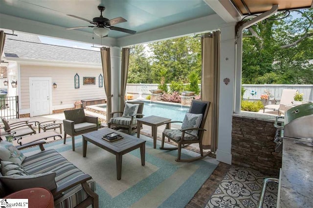 exterior space with a fenced in pool, outdoor lounge area, an outdoor kitchen, ceiling fan, and a fenced backyard