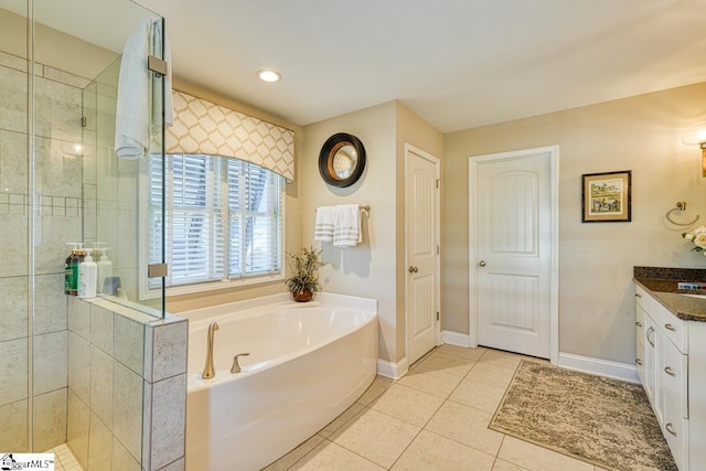 bathroom with baseboards, tiled shower, tile patterned floors, vanity, and a bath