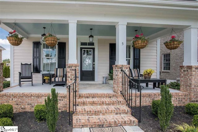 doorway to property featuring covered porch