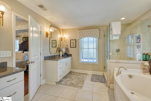 ensuite bathroom featuring a garden tub, tile patterned flooring, vanity, visible vents, and ensuite bath