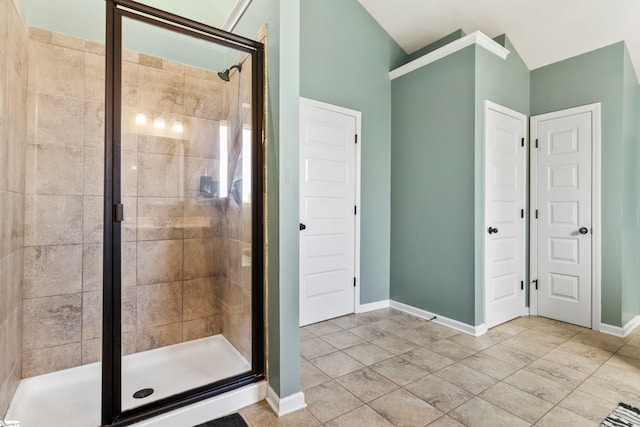 bathroom with a stall shower and baseboards