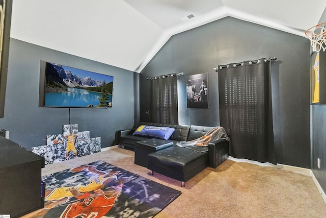 carpeted home theater room featuring vaulted ceiling and baseboards