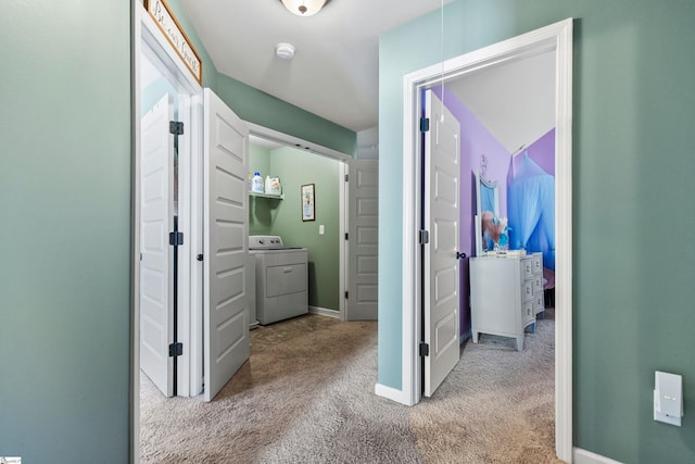 hallway featuring separate washer and dryer, carpet flooring, attic access, and baseboards