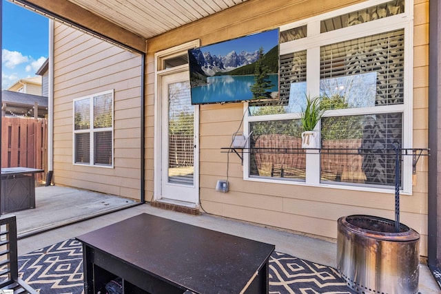 property entrance featuring a patio area and fence