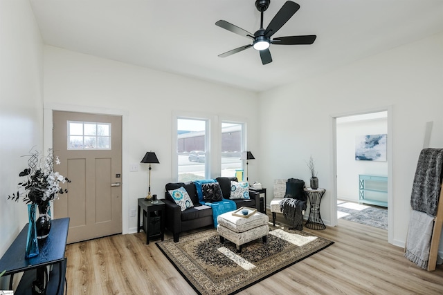 living room with wood finished floors, a wealth of natural light, and baseboards