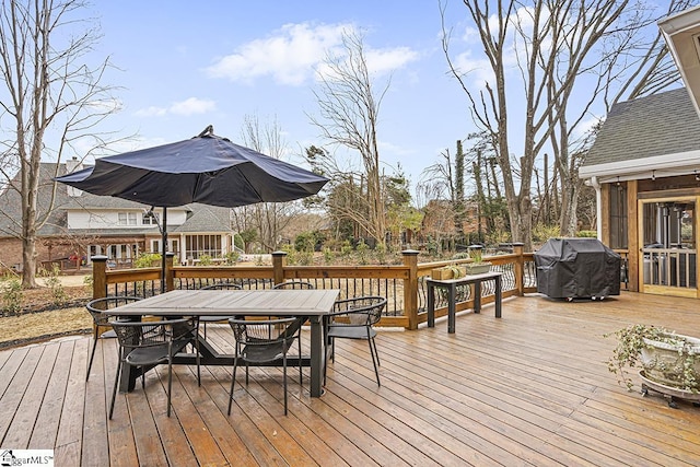 deck with outdoor dining space and area for grilling