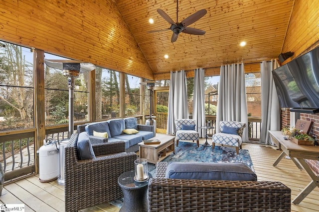 sunroom featuring lofted ceiling and a ceiling fan