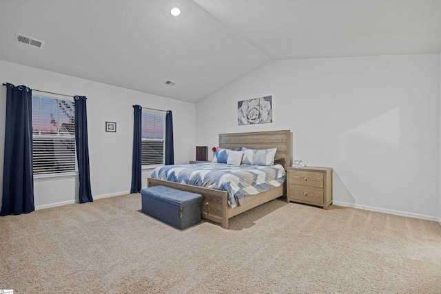 bedroom featuring lofted ceiling, baseboards, visible vents, and carpet flooring