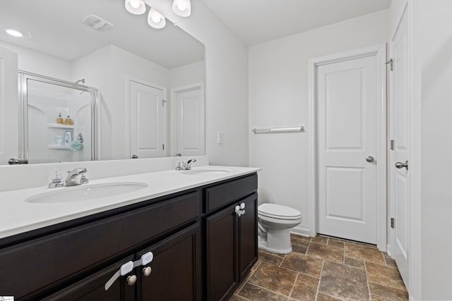 full bath with a stall shower, visible vents, a sink, and double vanity