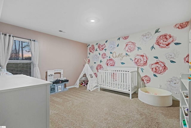 carpeted bedroom with visible vents, a crib, and baseboards