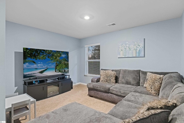 carpeted living area with baseboards and visible vents