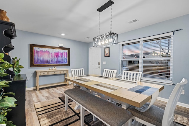 dining space with light wood-type flooring, baseboards, visible vents, and recessed lighting