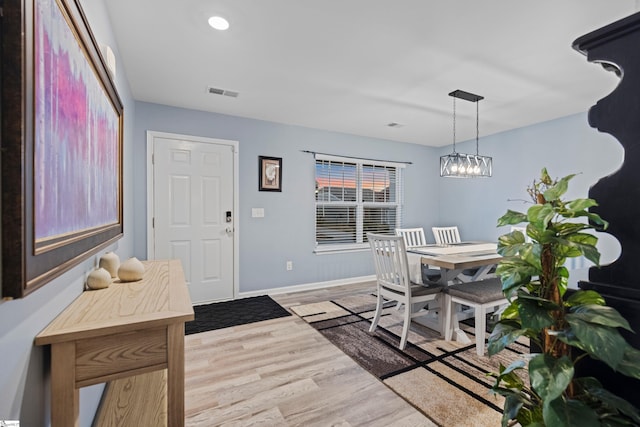 dining room featuring recessed lighting, baseboards, visible vents, and light wood finished floors