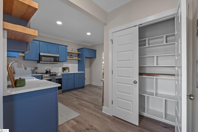 14 Arden Street Units A & B, Greenville, SC 29607 - kitchen with appliances with stainless steel finishes, ornamental molding, dark wood-type flooring, blue cabinets, and open shelves