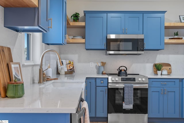 kitchen with stainless steel appliances, blue cabinets, a sink, and open shelves