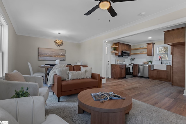 14 Arden Street Units A & B, Greenville, SC 29607 - living area featuring light wood-style floors, crown molding, and ceiling fan with notable chandelier