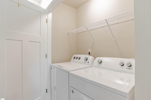 clothes washing area featuring washer and clothes dryer