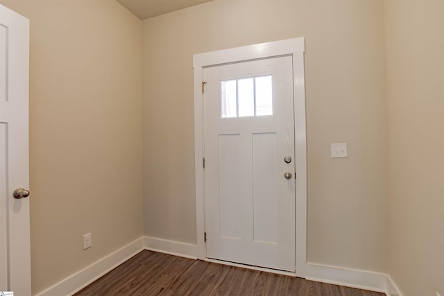 foyer entrance with dark wood-style floors and baseboards