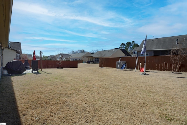 view of yard with fence and a residential view